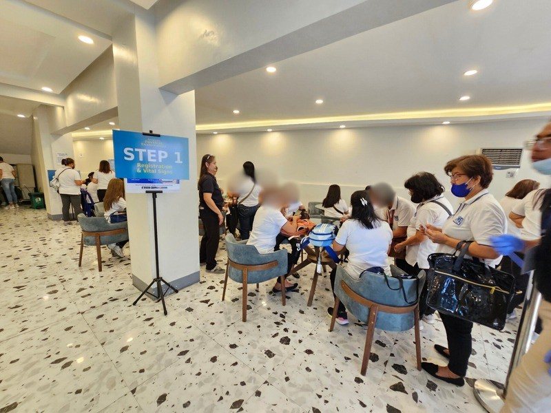 Residents queuing at stations during a YAKAP registration day